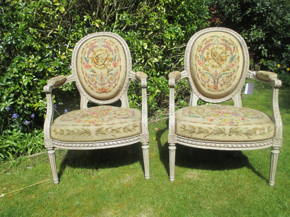 A Pair of painted needlepoint armchairs