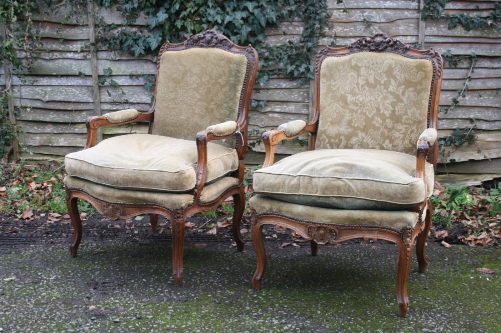 pair of french louis xv style armchairs in walnut 