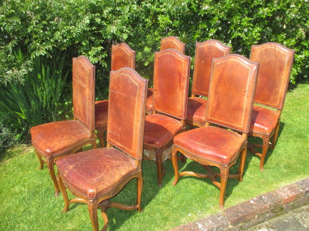 Eight leather high backed dining chairs