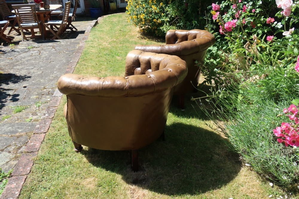 Pair of button-back leather tub chairs View V