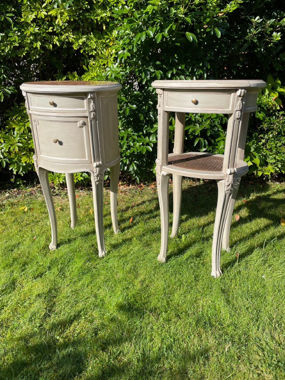 Pair of painted oval bedside tables 