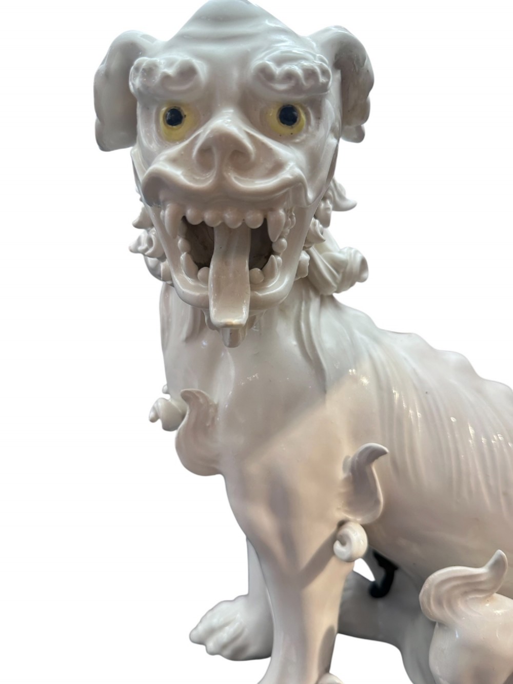 A pair of early 20th-century off-white porcelain Foo Dog table lamps with tall cream fabric shades. View II