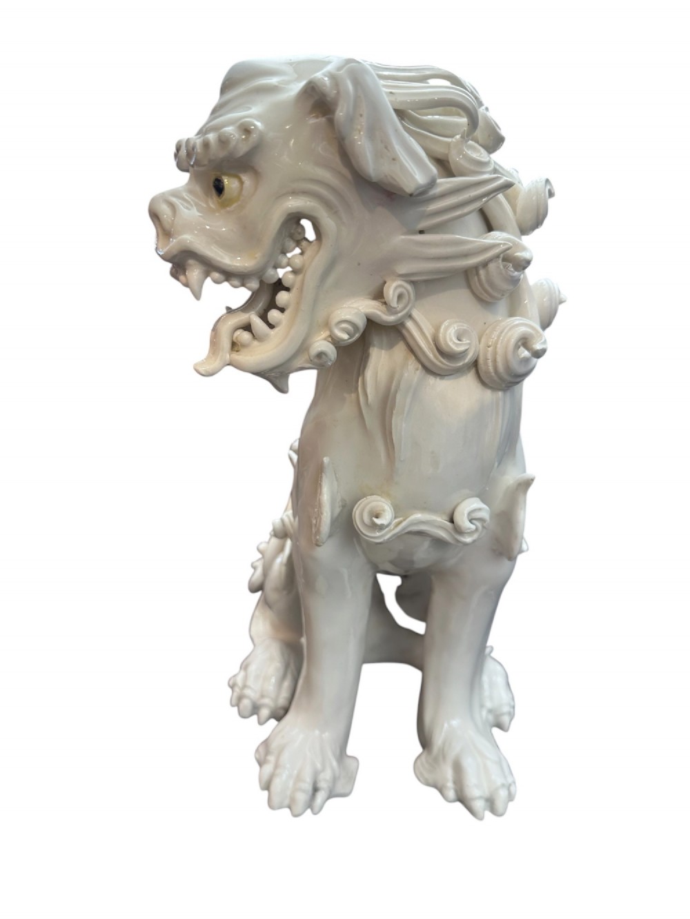 A pair of early 20th-century off-white porcelain Foo Dog table lamps with tall cream fabric shades. View IV