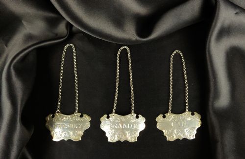 Three Victorian Silver Decanter Labels.