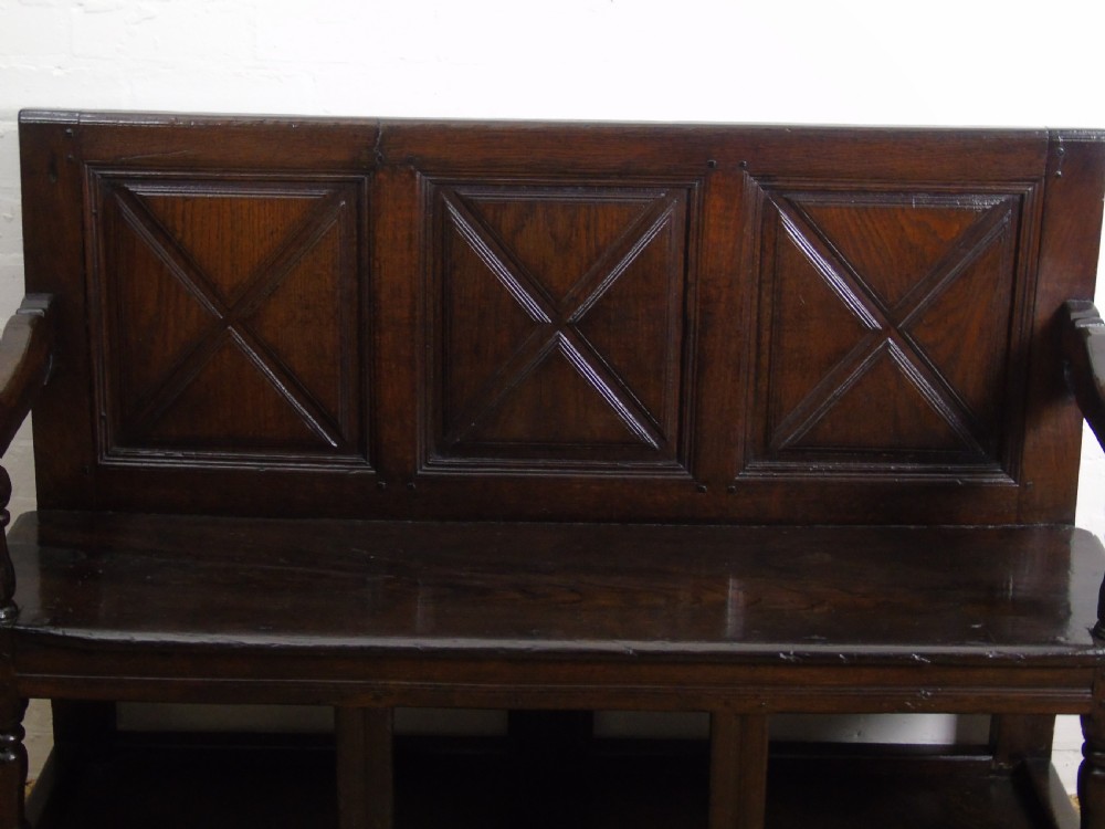 A rare and unusual early 17th Century settle.  View VI