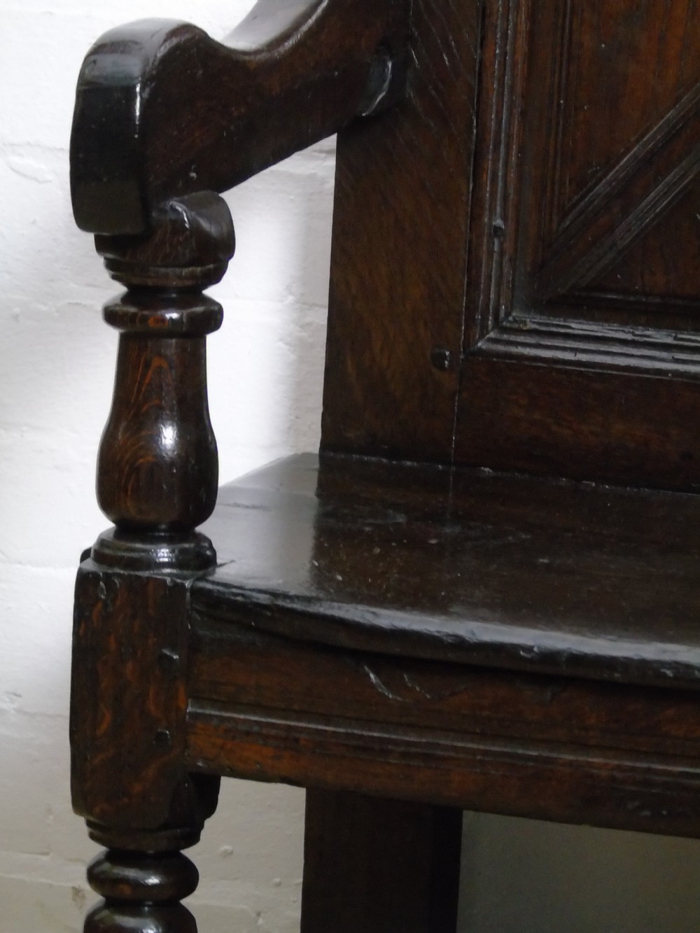 A rare and unusual early 17th Century settle.  View IX