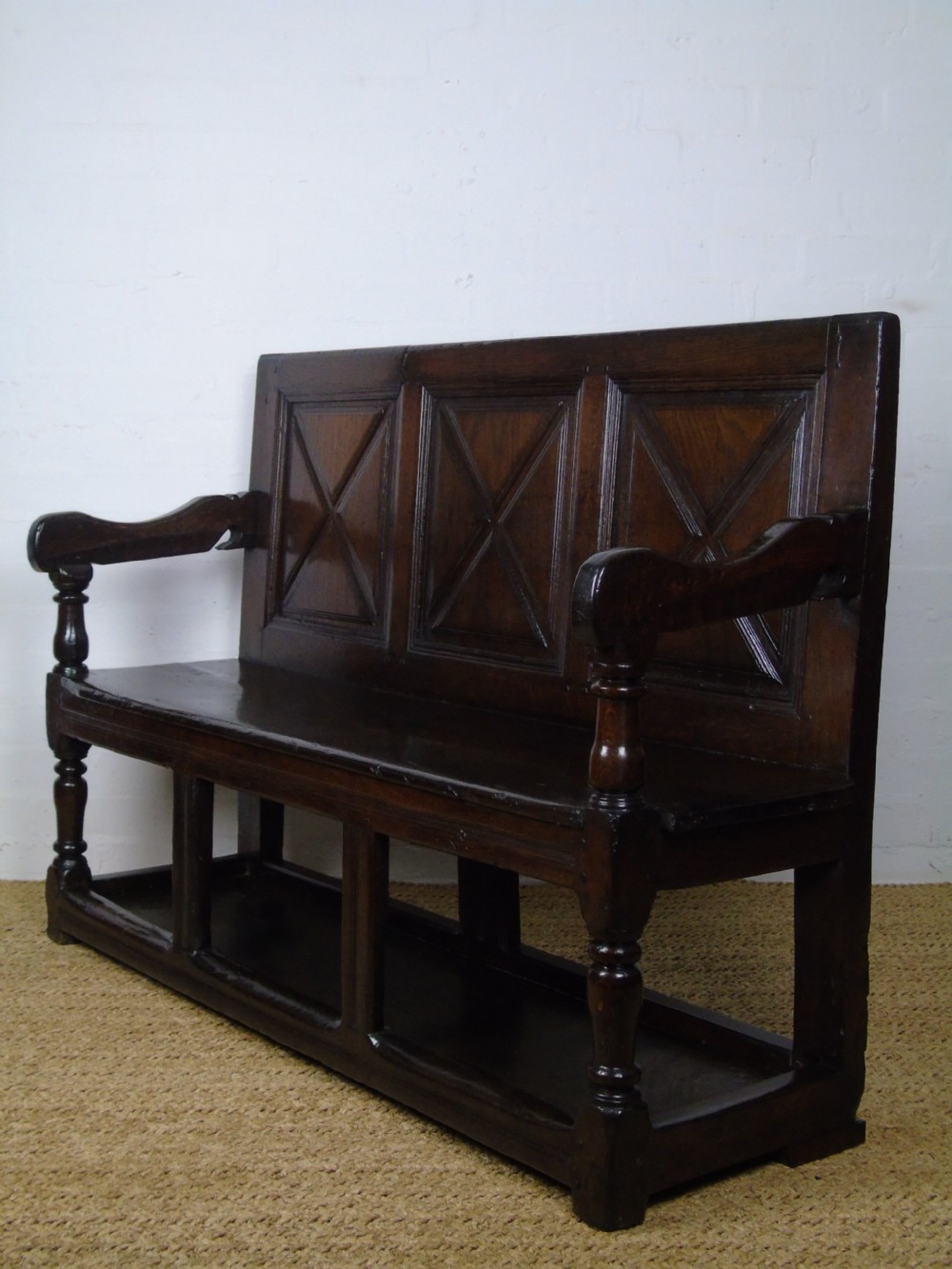 A rare and unusual early 17th Century settle.  View XIX