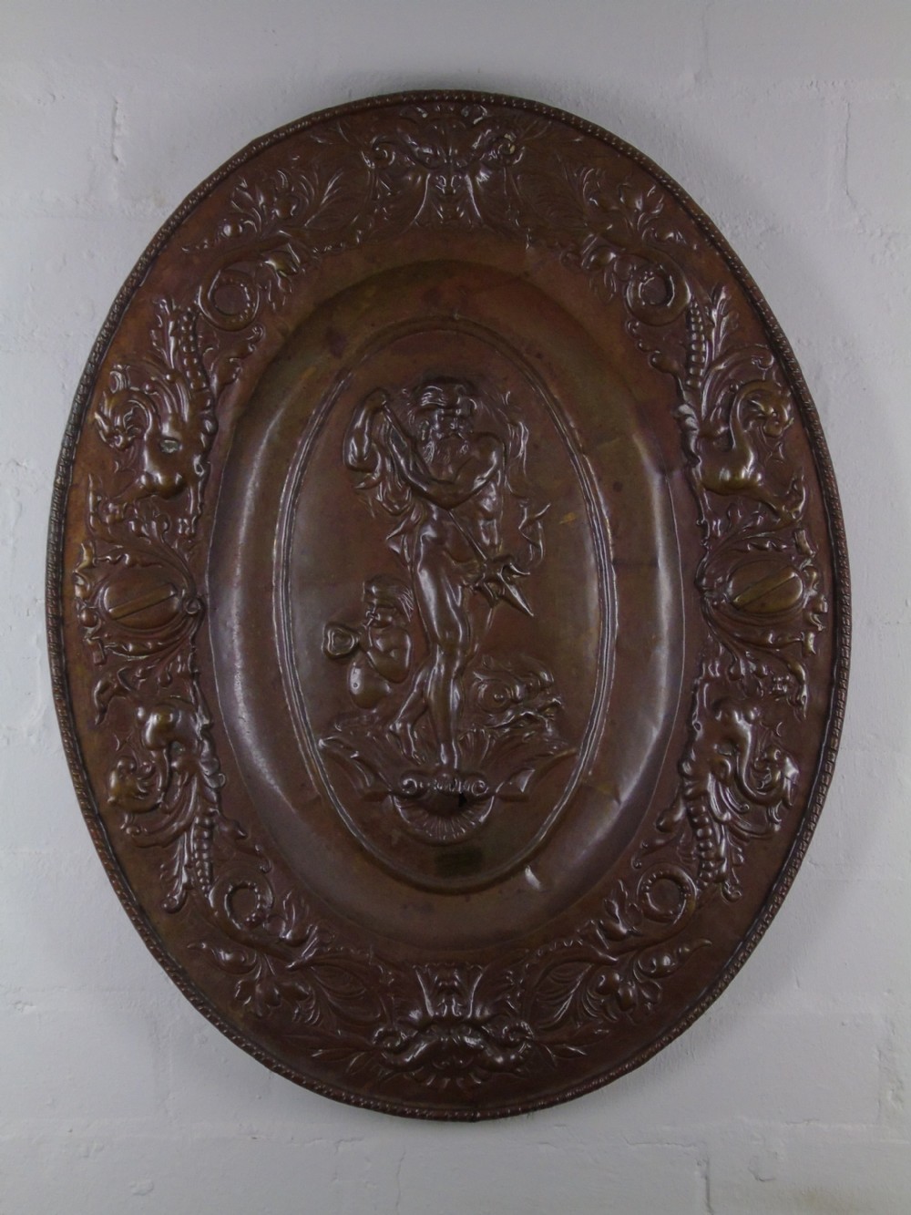 An early 18th Century repousse copper wall hanging platter