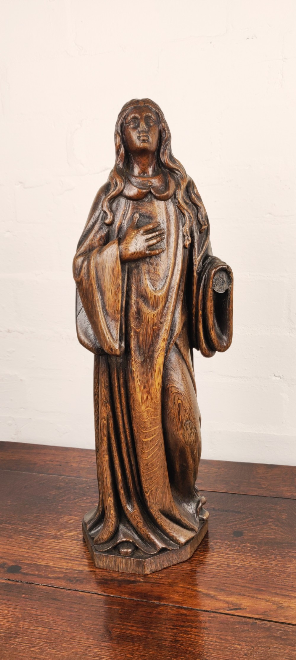 A late 17th Century carved figure depicting Saint Agnes 