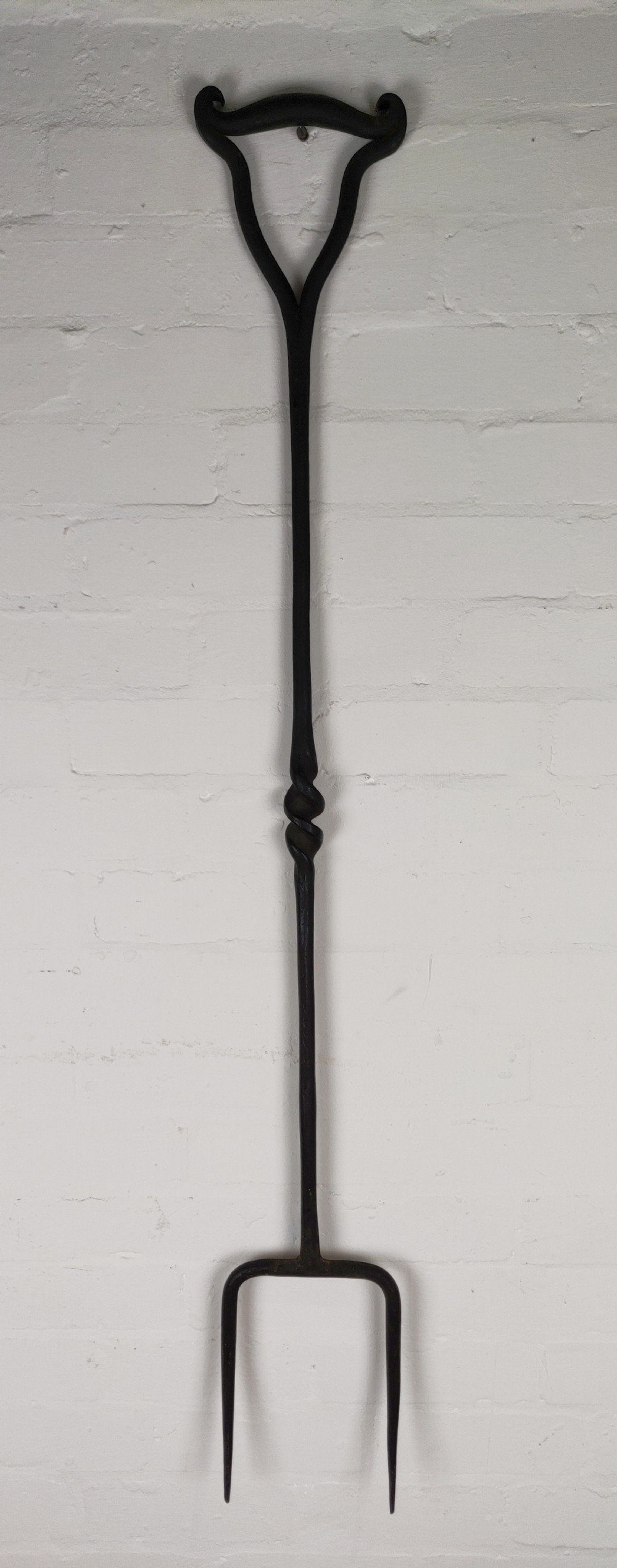 A large 19th century wrought iron log fork. 