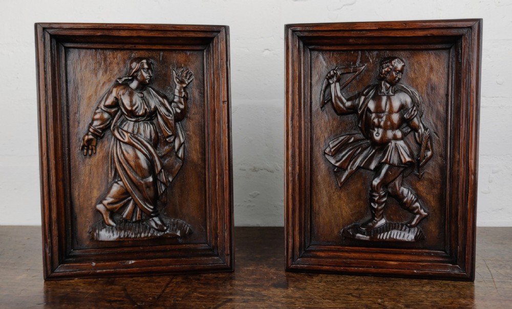 A pair of 17th century carved panels depicting Odysseus.