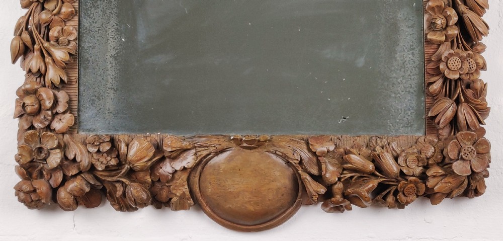 After Grinling Gibbons - a fine 18thC carved mirror. View IV