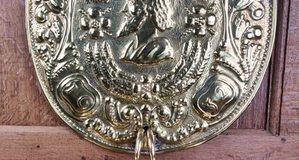 A decorative pair of 19thC repoussé brass wall sconces.  View IV
