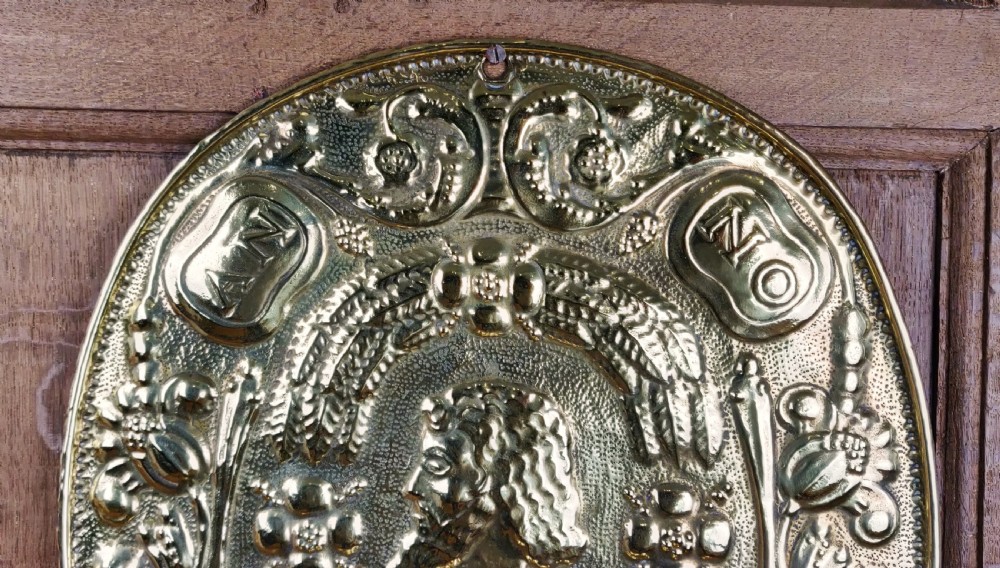 A decorative pair of 19thC repoussé brass wall sconces.  View V
