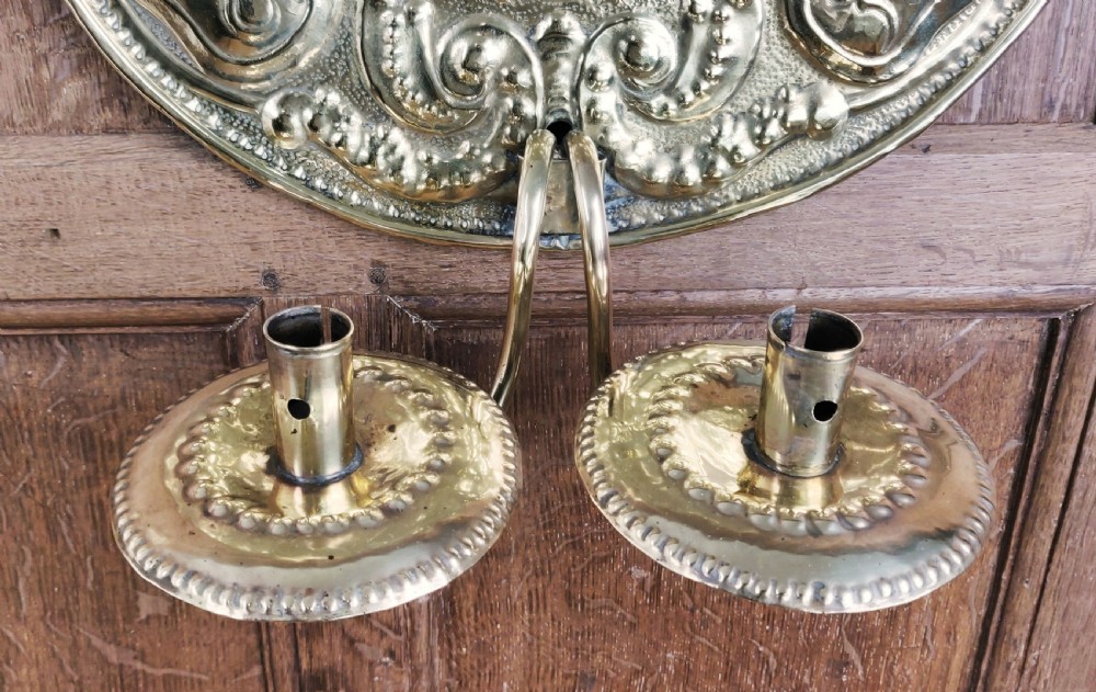 A decorative pair of 19thC repoussé brass wall sconces.  View VI