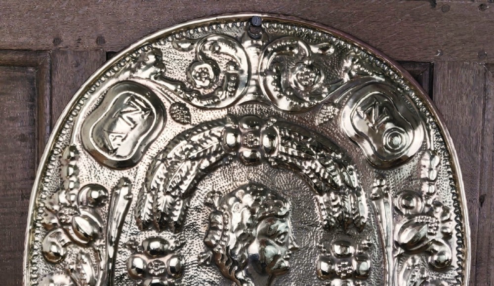 A decorative pair of 19thC repoussé brass wall sconces.  View VIII