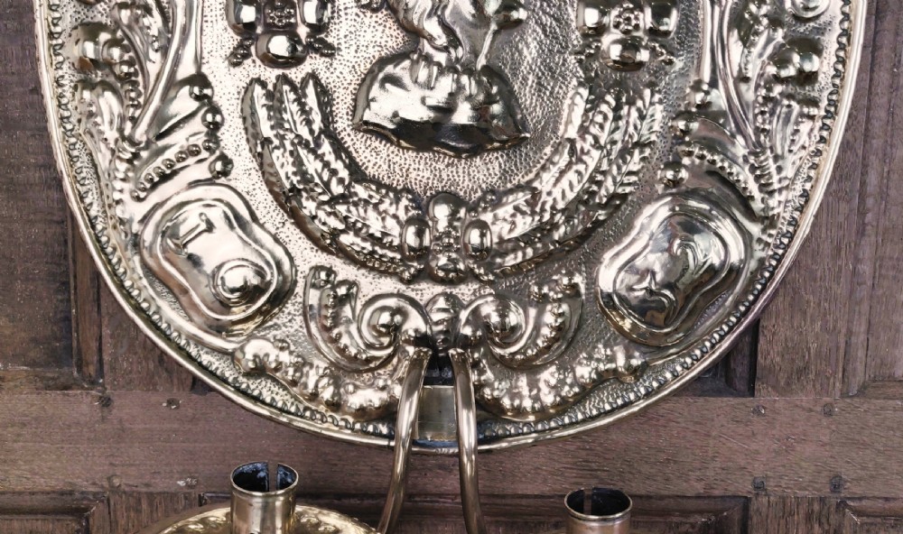 A decorative pair of 19thC repoussé brass wall sconces.  View IX