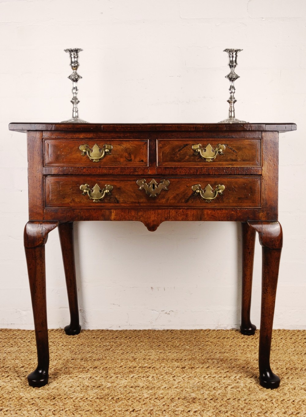 A small 18th century walnut lowboy. 