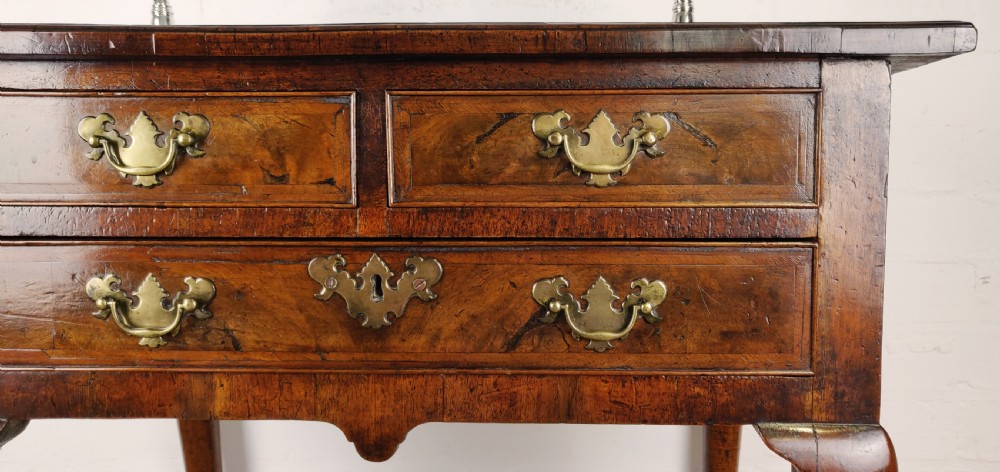 A small 18th century walnut lowboy.  View IV