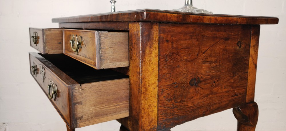 A small 18th century walnut lowboy.  View VIII