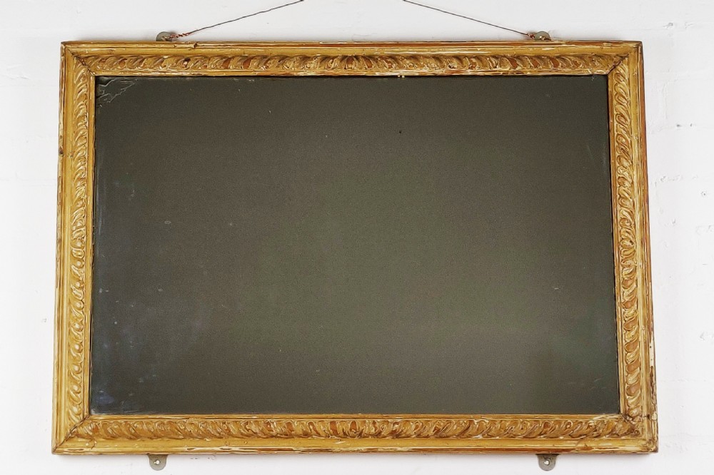 A late 18th - early 19th century carved mirror. 