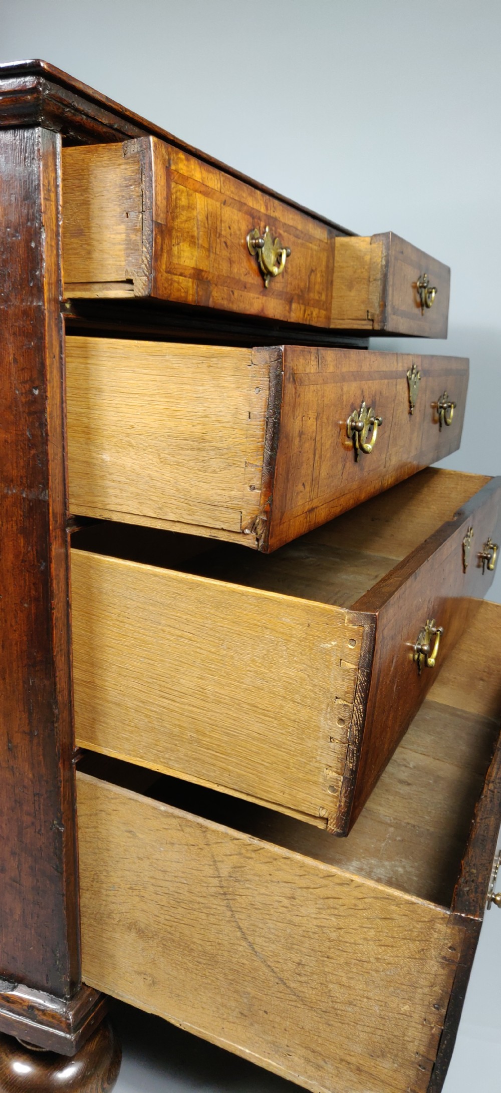 An early 18th century walnut chest of drawers.  View X