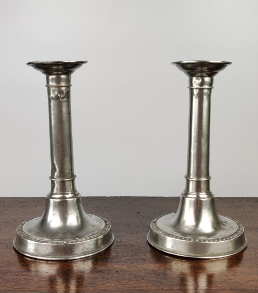 A pair of Queen Anne Candlesticks.