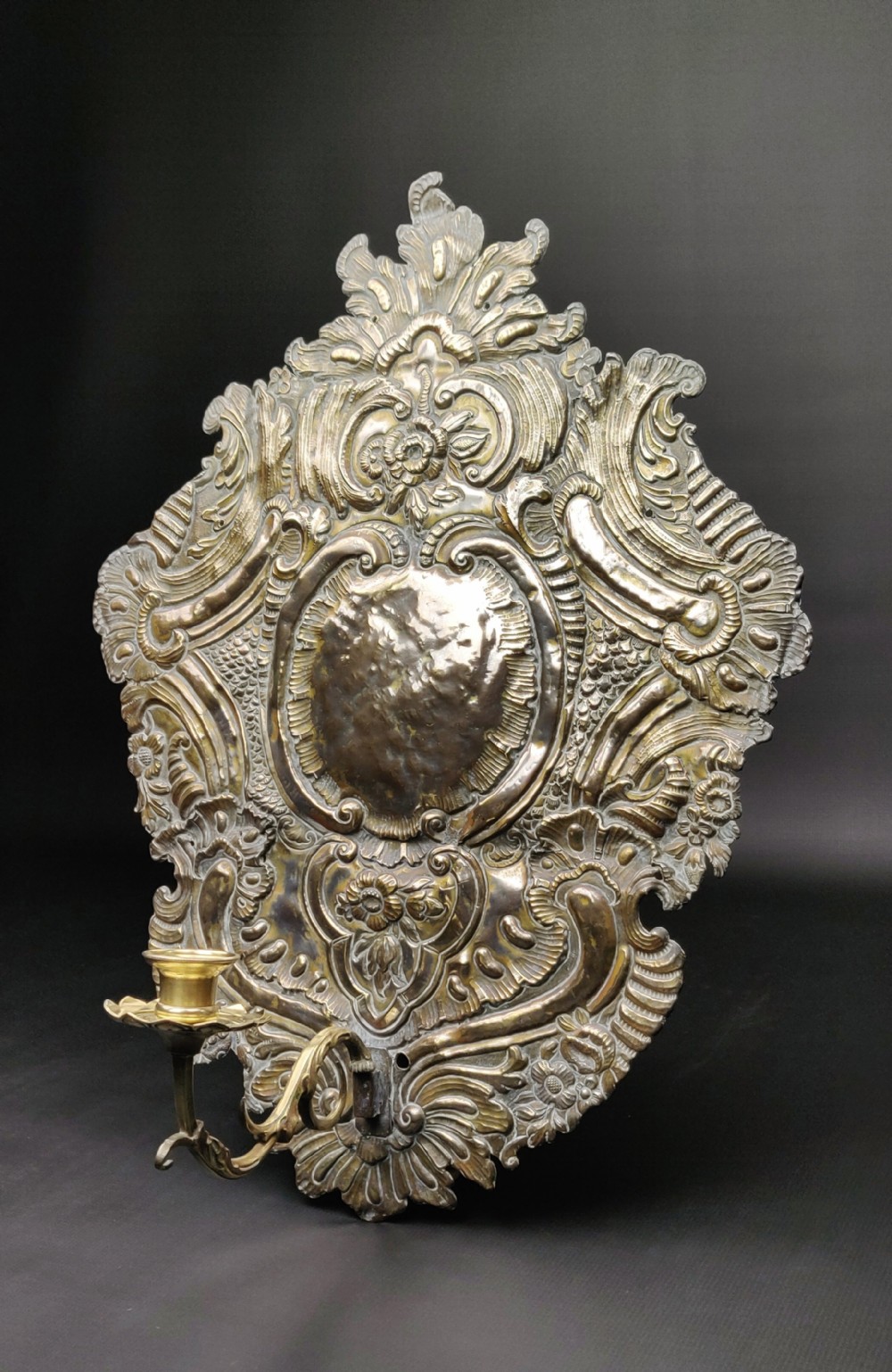 A large early 18th century silvered repoussé wall sconce. 