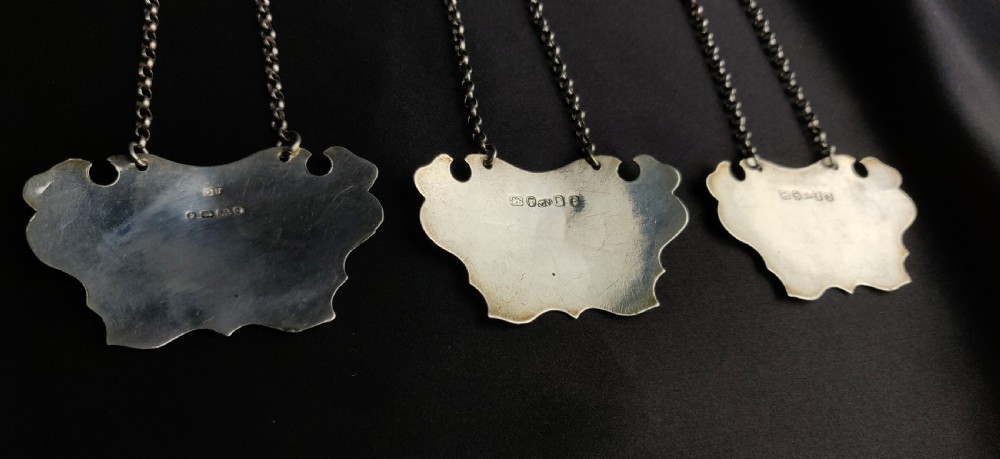 Three Victorian silver decanter labels.  View II