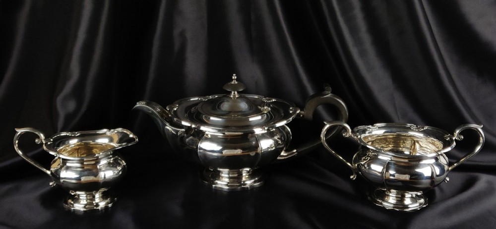 A 1930's three piece silver tea set by Walker & Hall. 