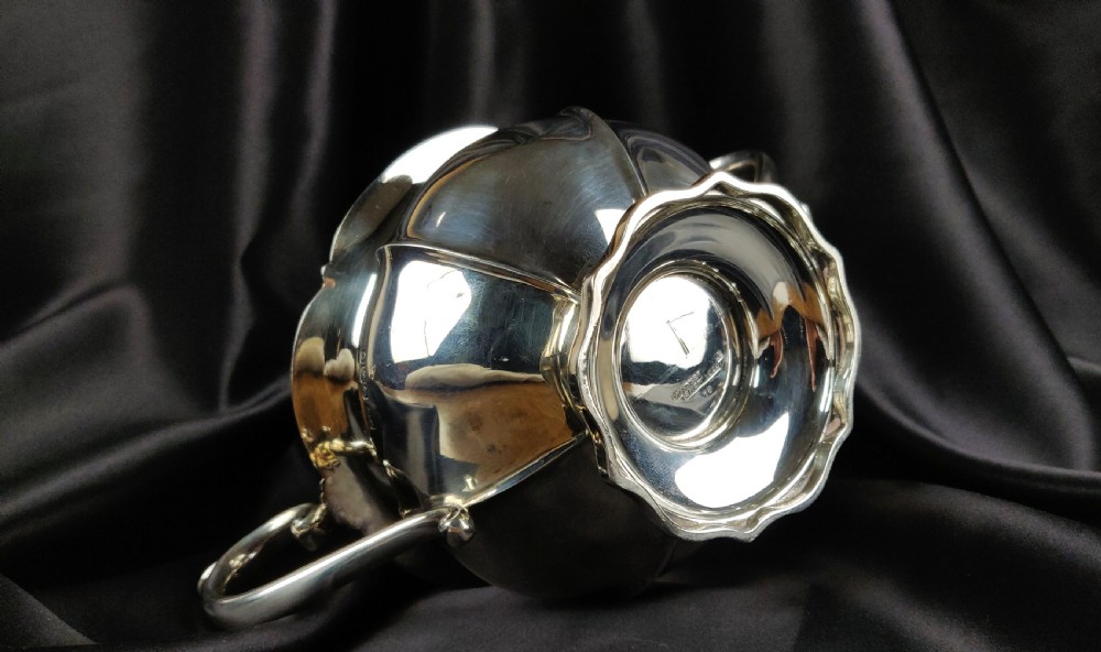 A 1930's three piece silver tea set by Walker & Hall.  View XIV