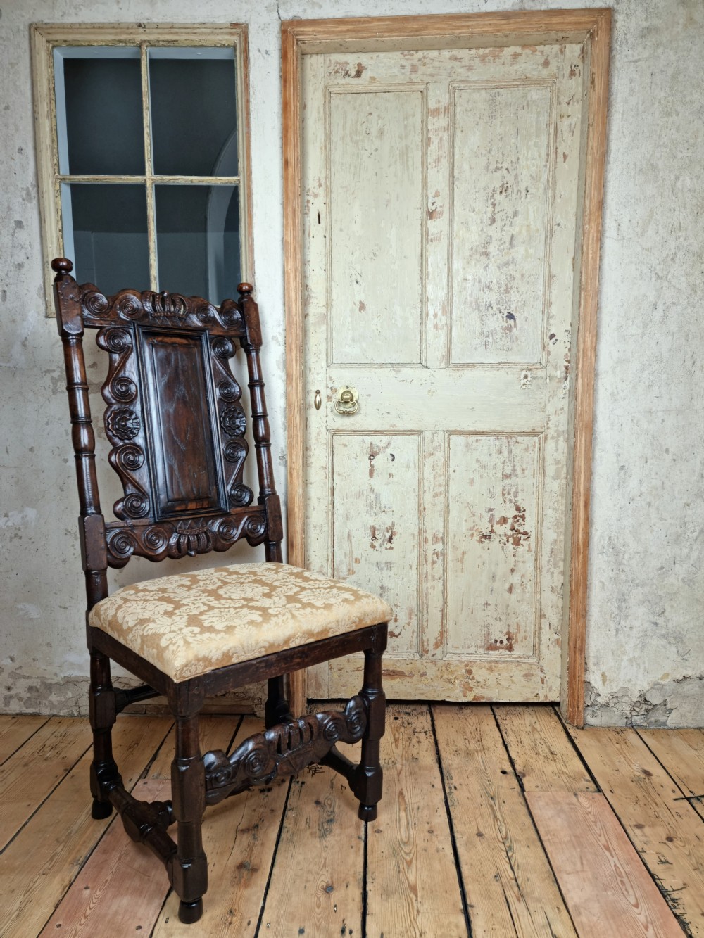 A late 17th century hall chair. 