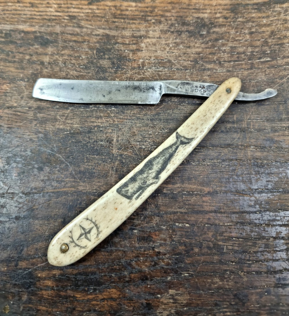 A 19th century sailors, scrimshaw cut throat razor. 