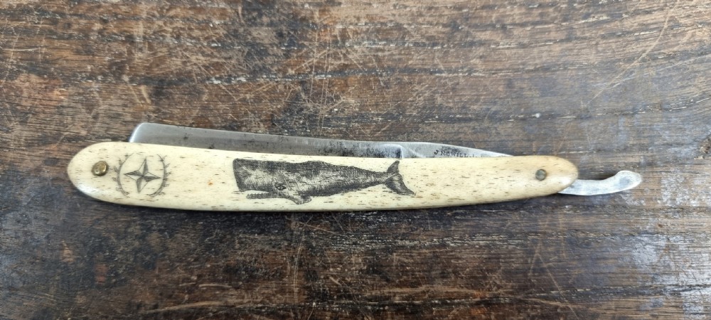 A 19th century sailors, scrimshaw cut throat razor.  View II
