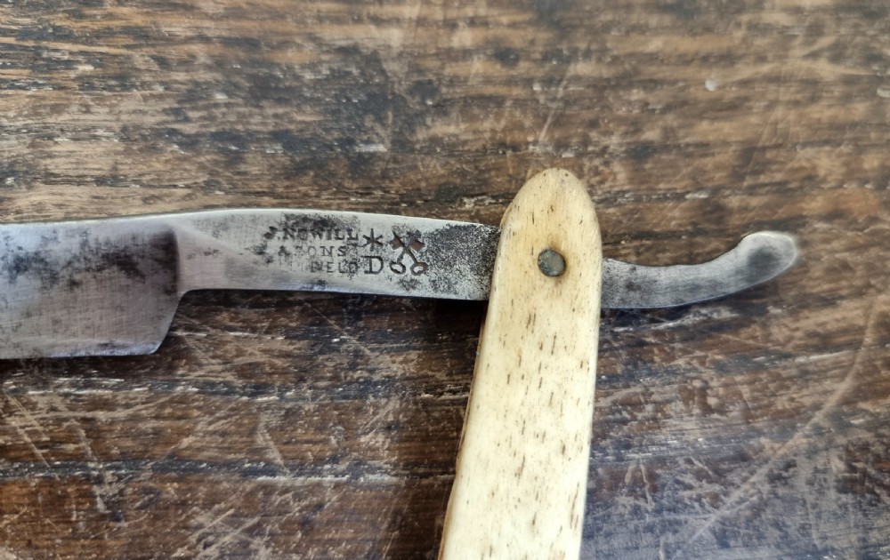 A 19th century sailors, scrimshaw cut throat razor.  View V