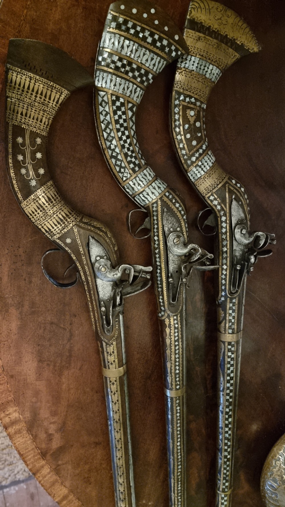 Three north western frontier flintlock muskets.  View II