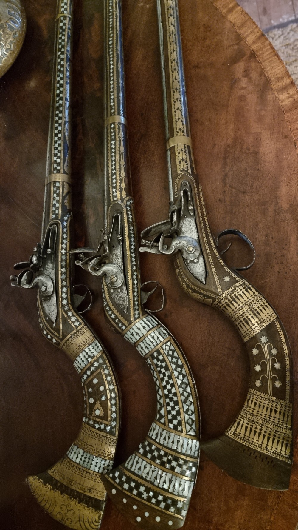 Three north western frontier flintlock muskets. 